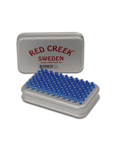 Red Creek handborste i blå nylon med tillhörande silverfärgad behållare.