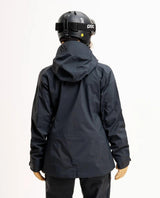 Baksida av Elevenate Pure Jacket Women i färgen Dark Ink Solid på en skidåkare med hjälm.
