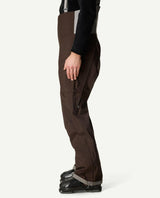 Sidovy på Houdini Rollercoaster Bib Pants II skidbyxor för herr i brunt.