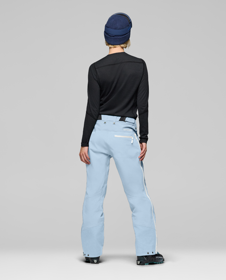 Norrøna Lofoten Gore-Tex Pro Skidbyxor Dam i färgen Cashmere Blue bakifrån visade med pjäxor.