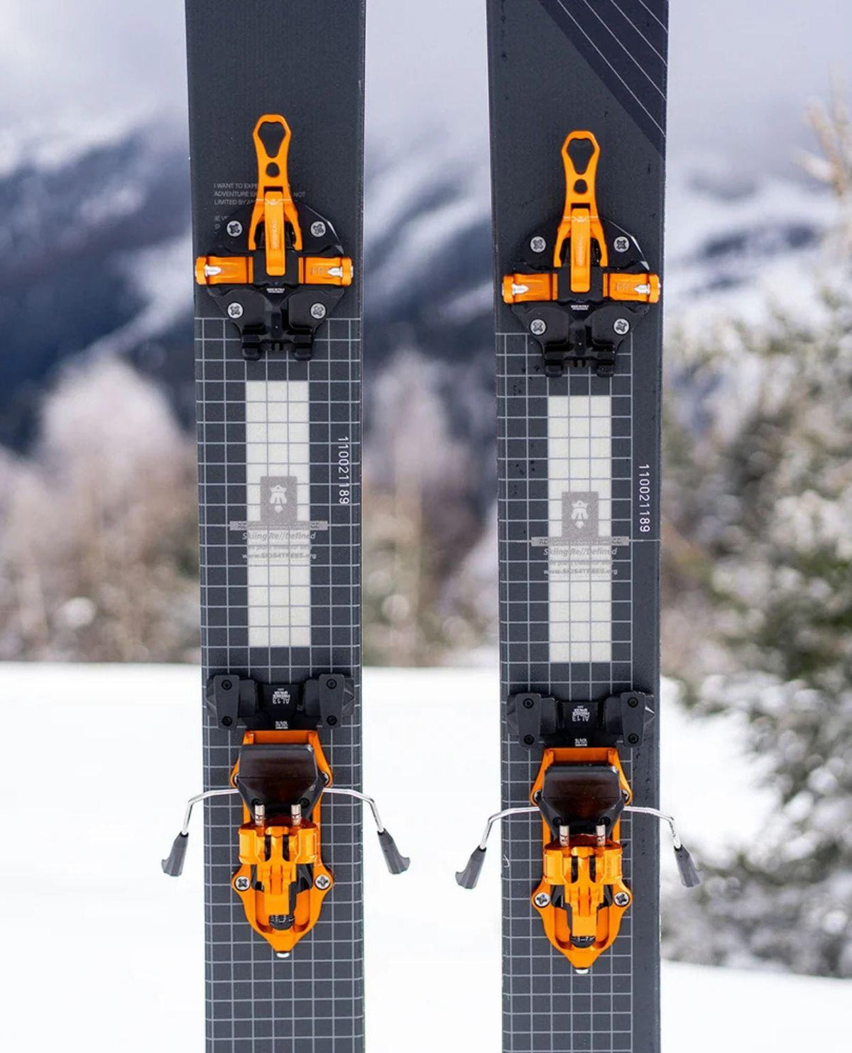 ATK Freeraider 15 EVO oranga topptursbindningar monterade på skidor för friåkning.