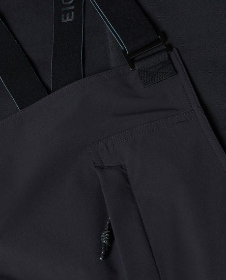 Mammut Eiger Free Pro HS Bib Pants dam i svart färg som visar detaljer på hängslen och bröstficka.